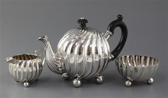 A late Victorian spiral fluted globular three piece tea set by Moritz & Simon Lothiem, gross 28 oz